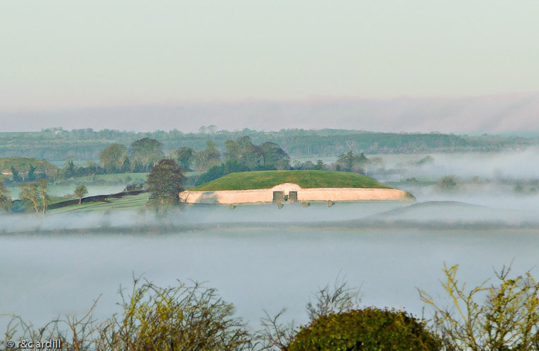 An early morning view of Newgrange with the Boyne valley shrouded in mist